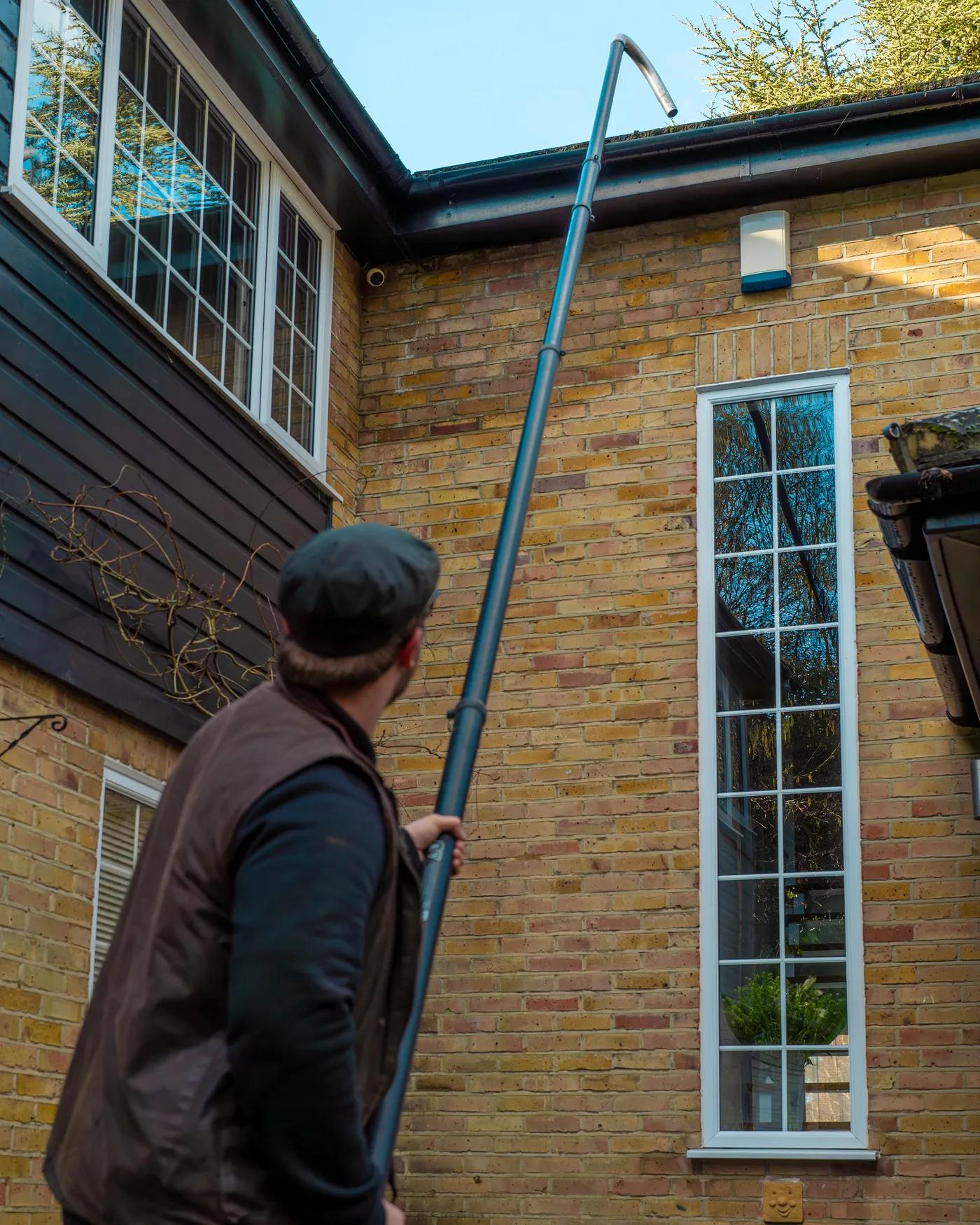 A Willow Alexander team clearing gutters from the ground with a SkyVac, 6