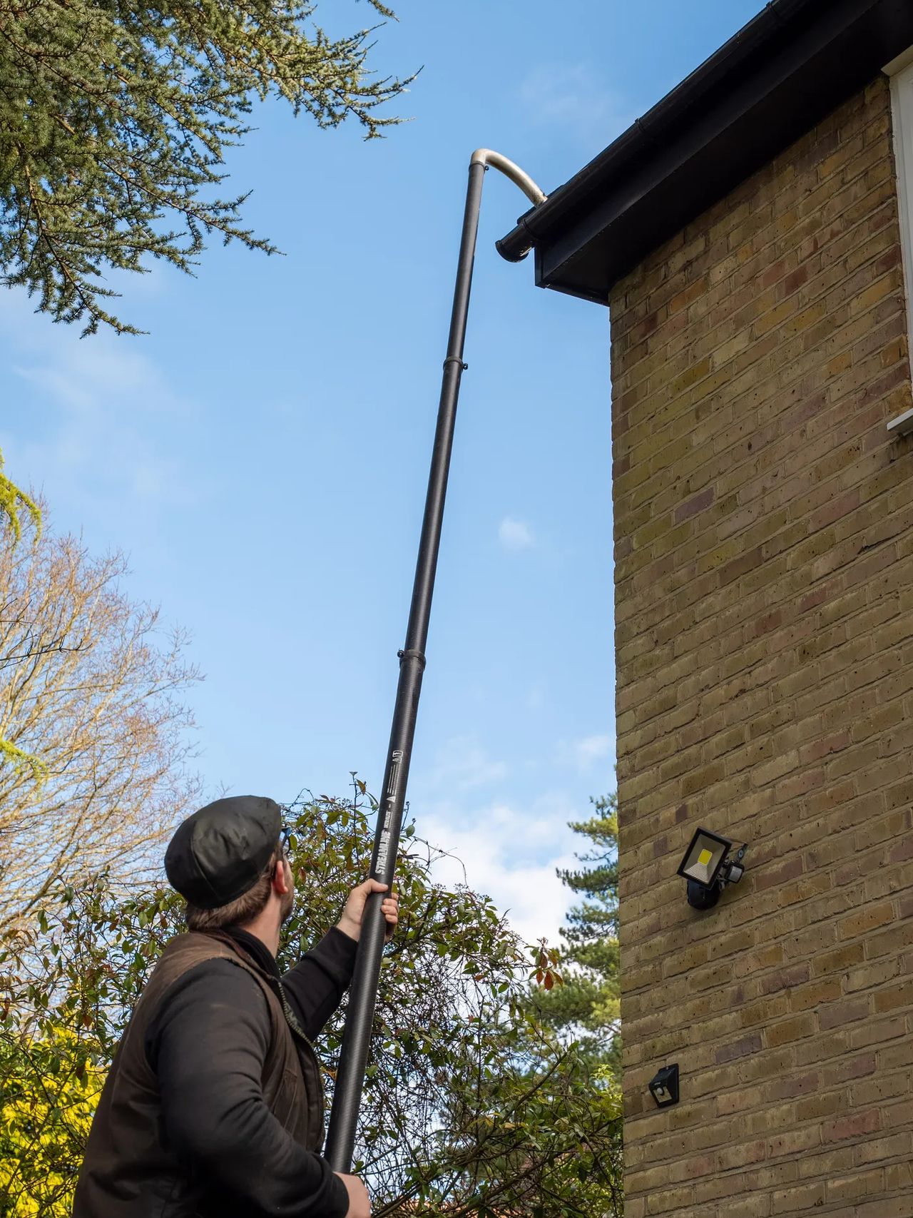 A Willow Alexander team clearing gutters from the ground with a SkyVac, 2