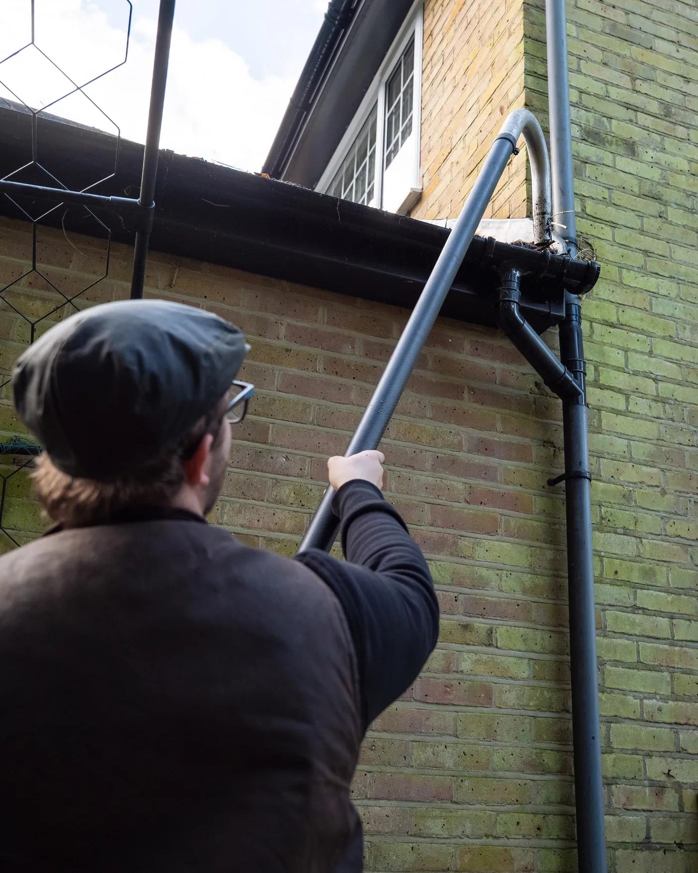 A Willow Alexander team clearing gutters from the ground with a SkyVac, 5