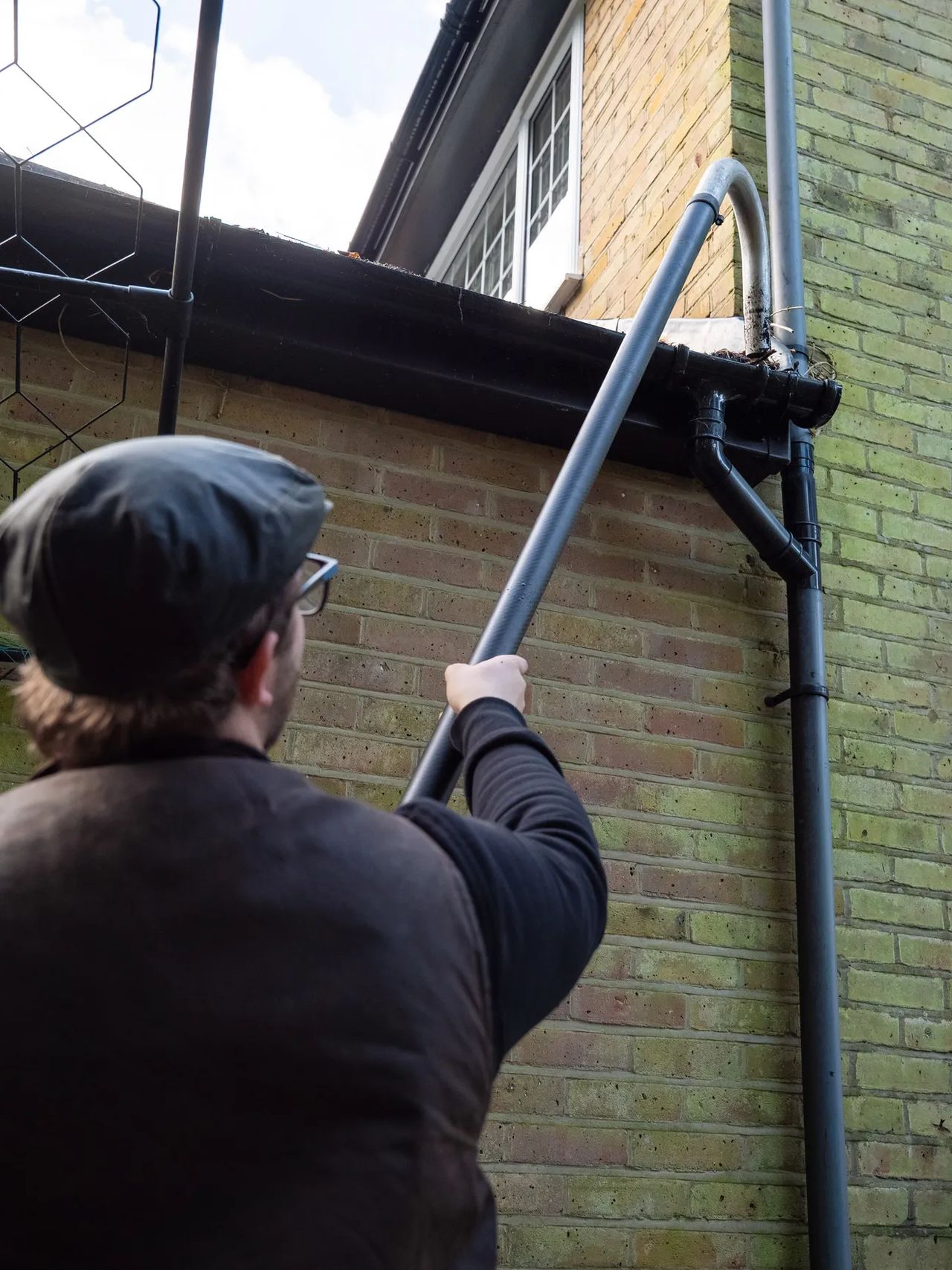 A Willow Alexander team clearing gutters from the ground with a SkyVac, 5