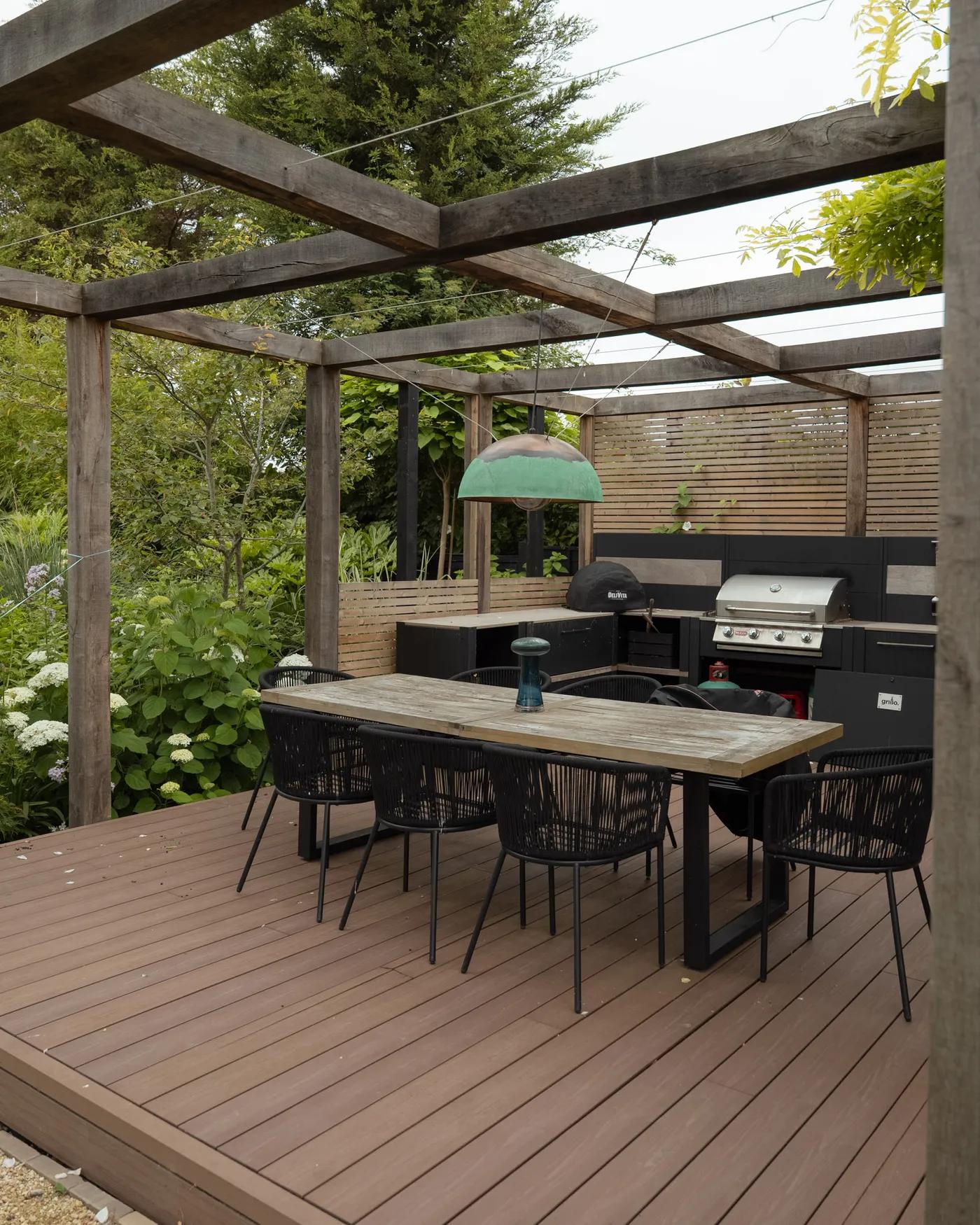 Composite decking dining area under a pergola