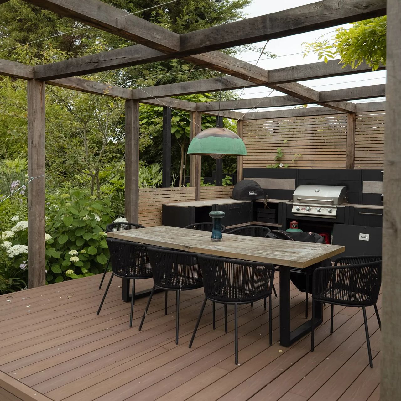 Composite decking dining area under a pergola