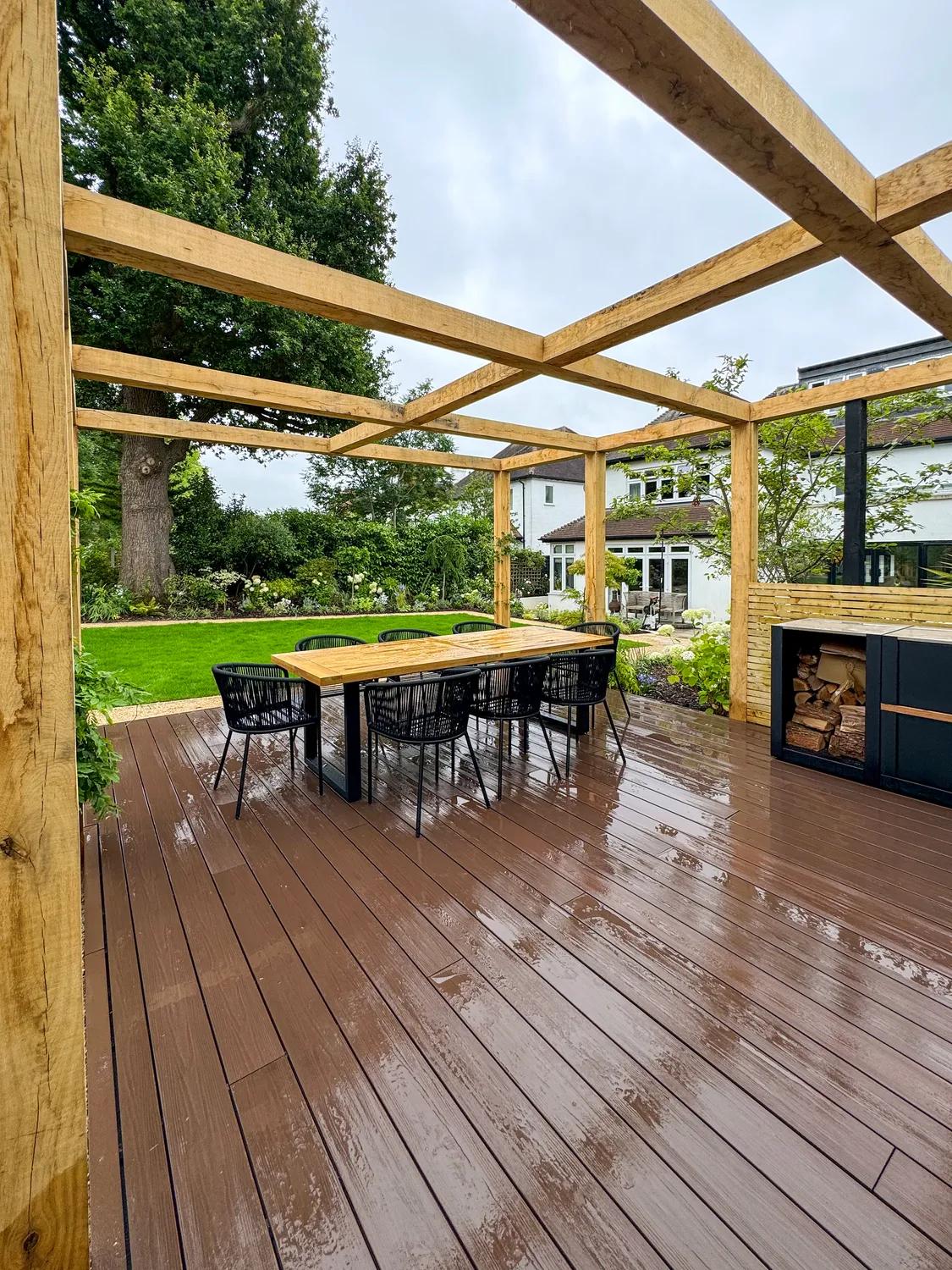 Warm umber composite decking beneath a timber pergola
