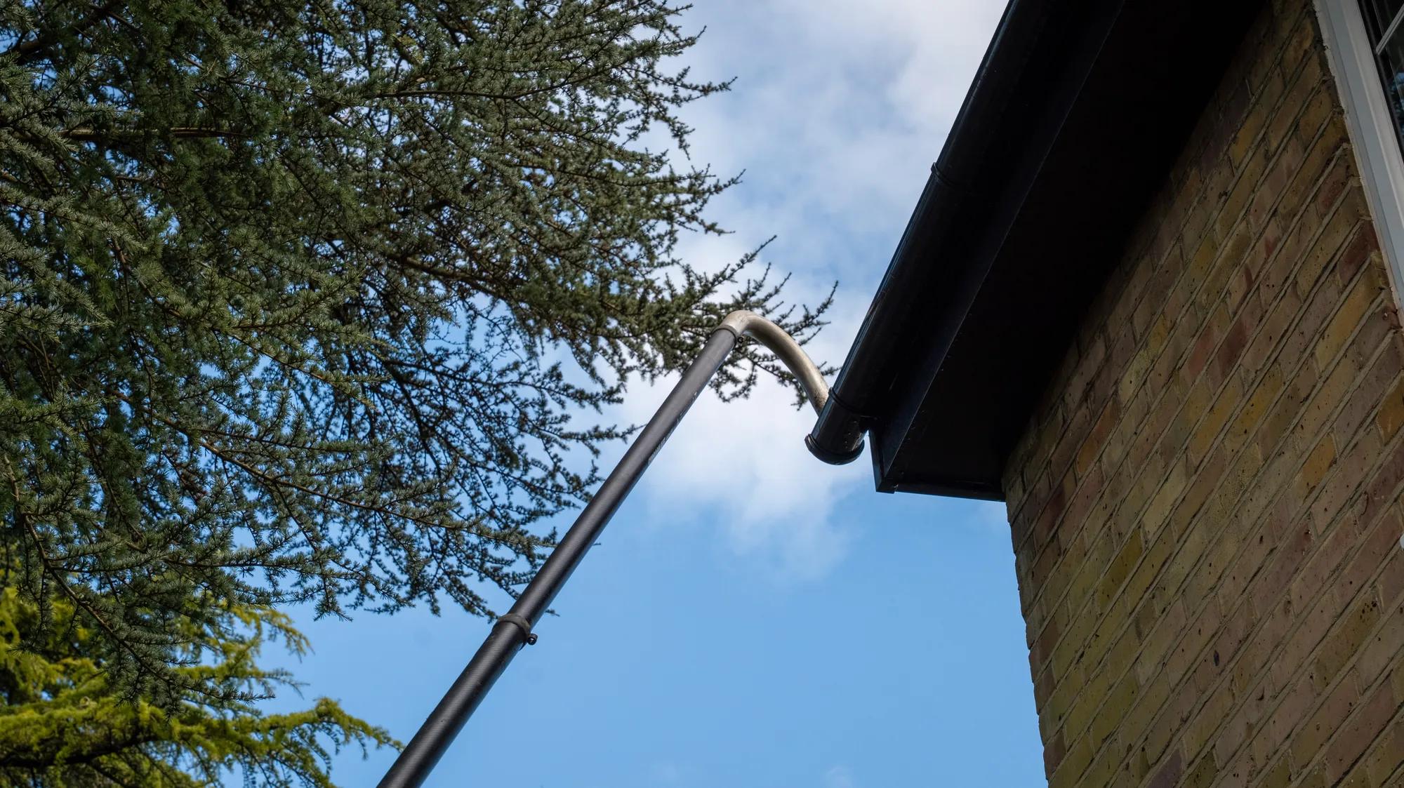 A Willow Alexander team clearing gutters from the ground with a SkyVac