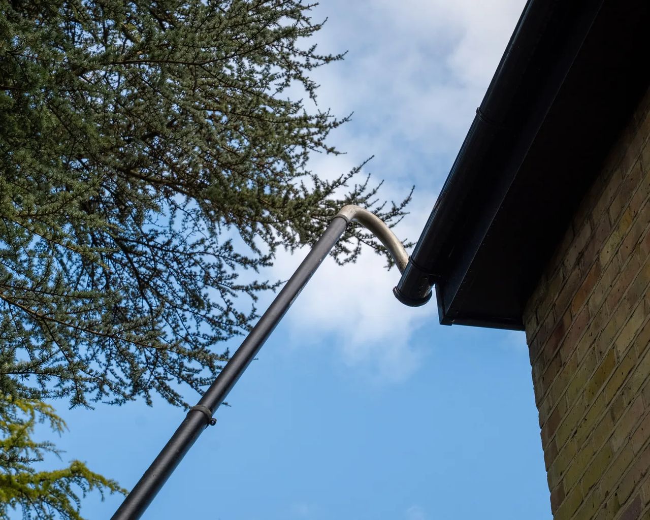 A Willow Alexander team clearing gutters from the ground with a SkyVac