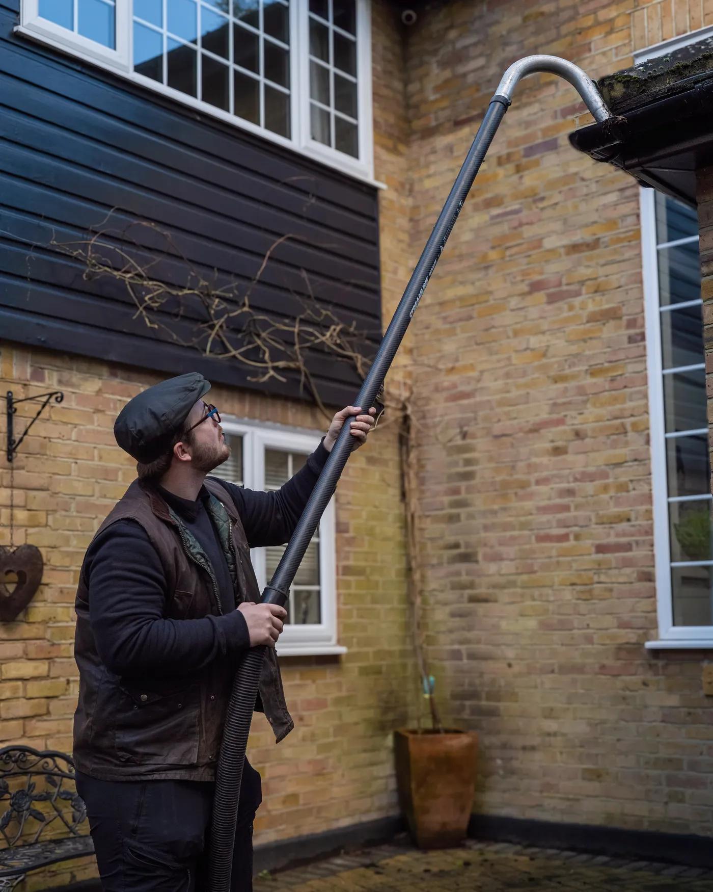 A Willow Alexander team clearing gutters from the ground with a SkyVac, 4