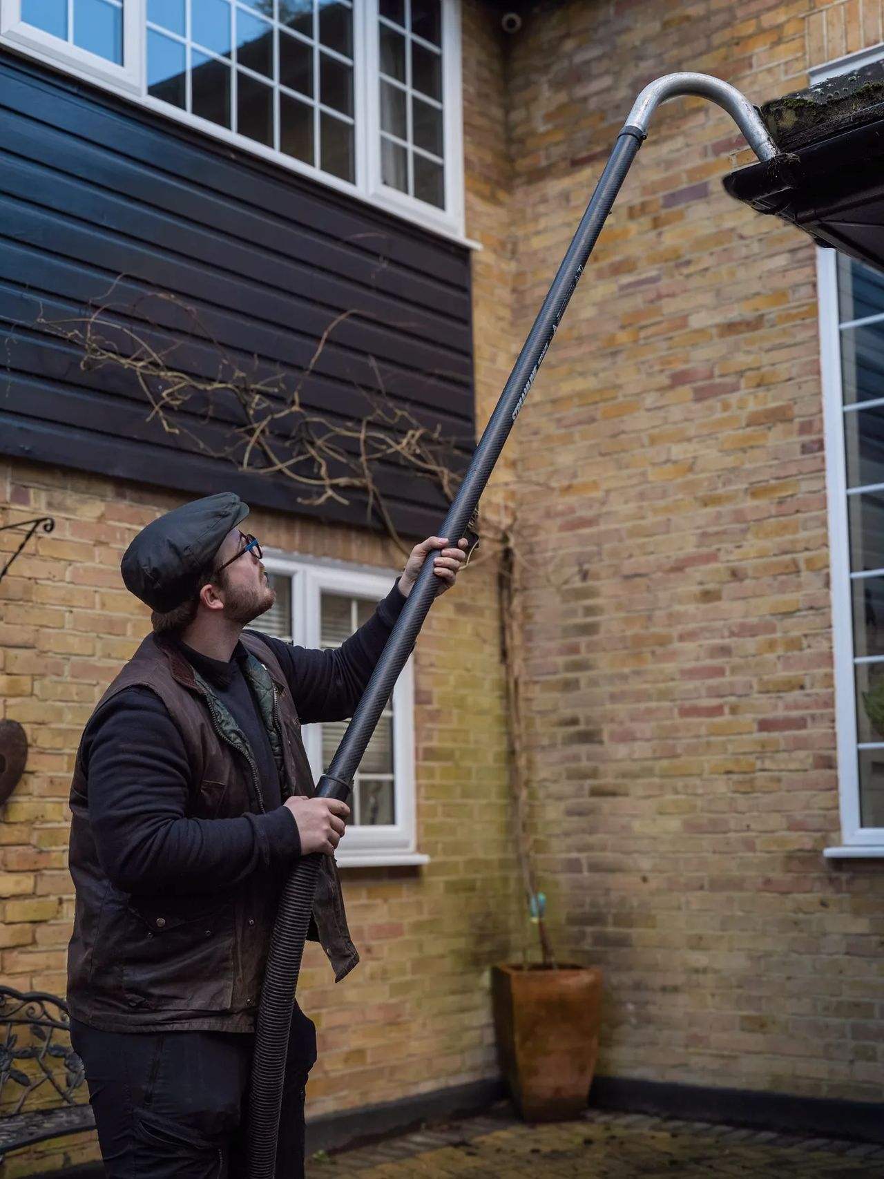 A Willow Alexander team clearing gutters from the ground with a SkyVac, 4