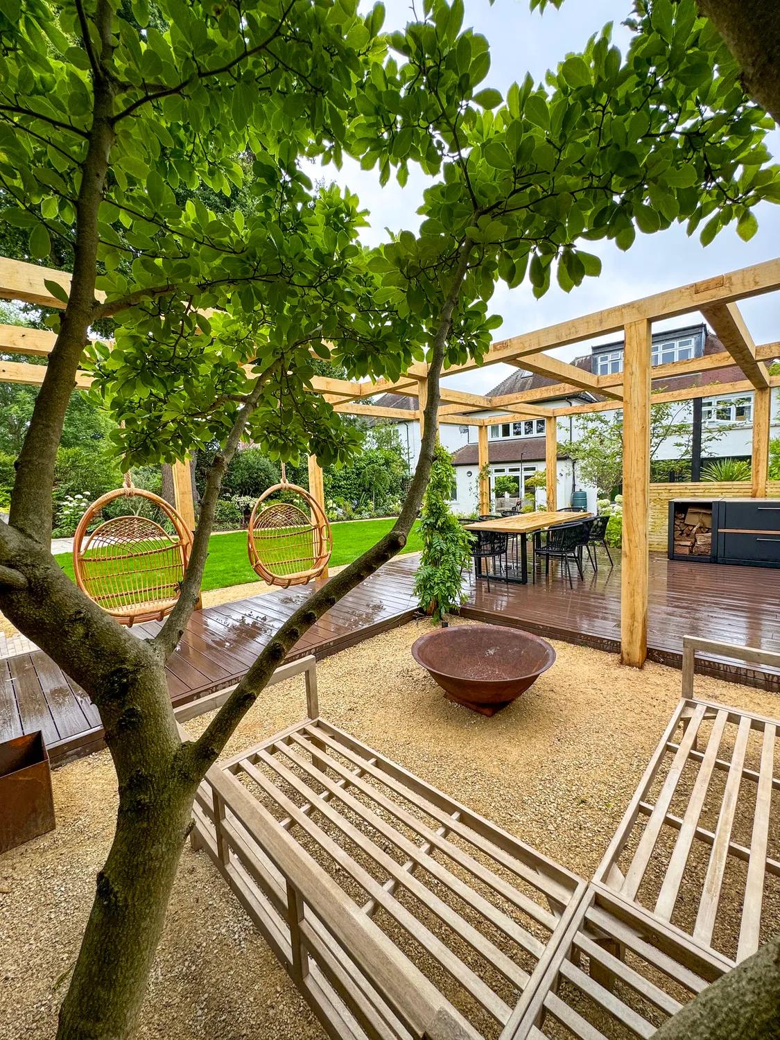 A pergola dining area viewed across the garden