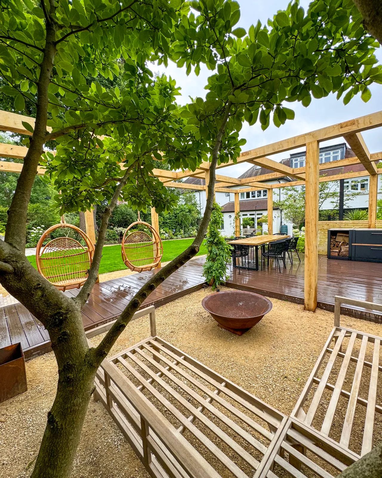 A pergola dining area viewed across the garden