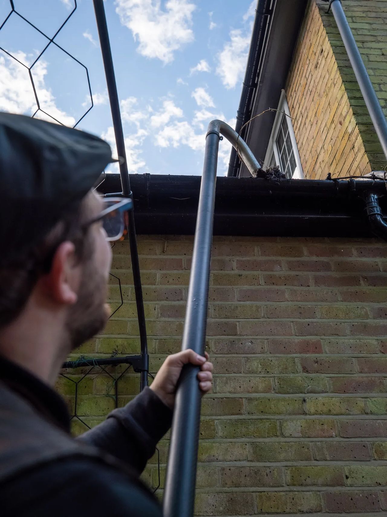 A Willow Alexander team clearing gutters from the ground with a SkyVac, 1
