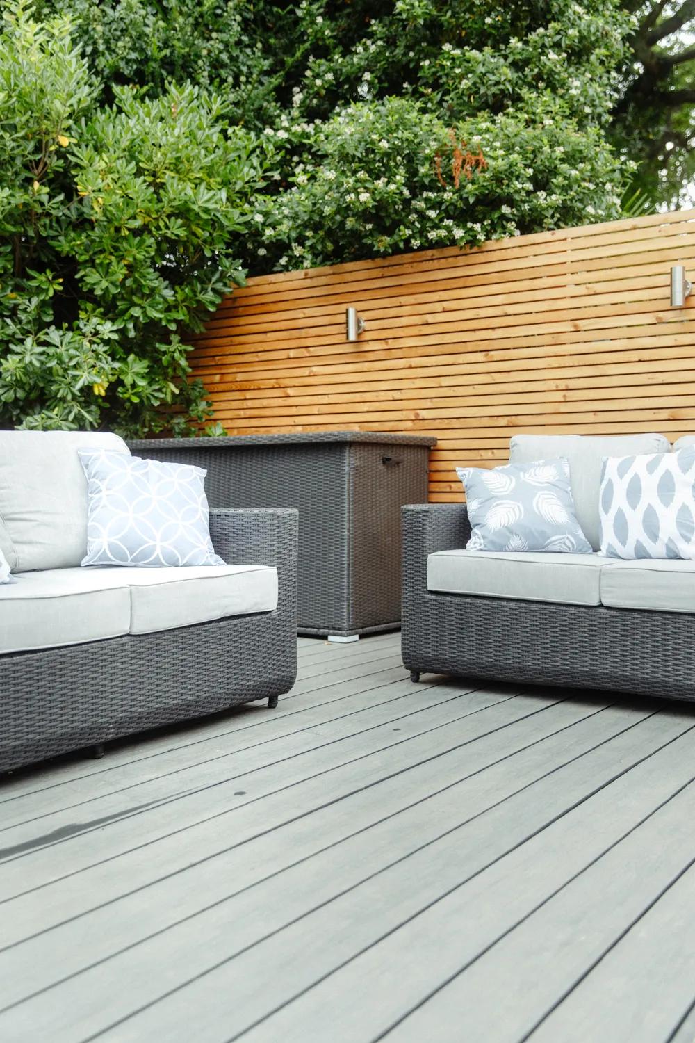 Slate-grey composite decking with a cedar slatted screen