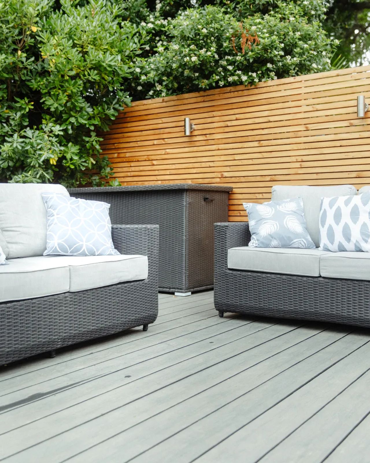 Slate-grey composite decking with a cedar slatted screen