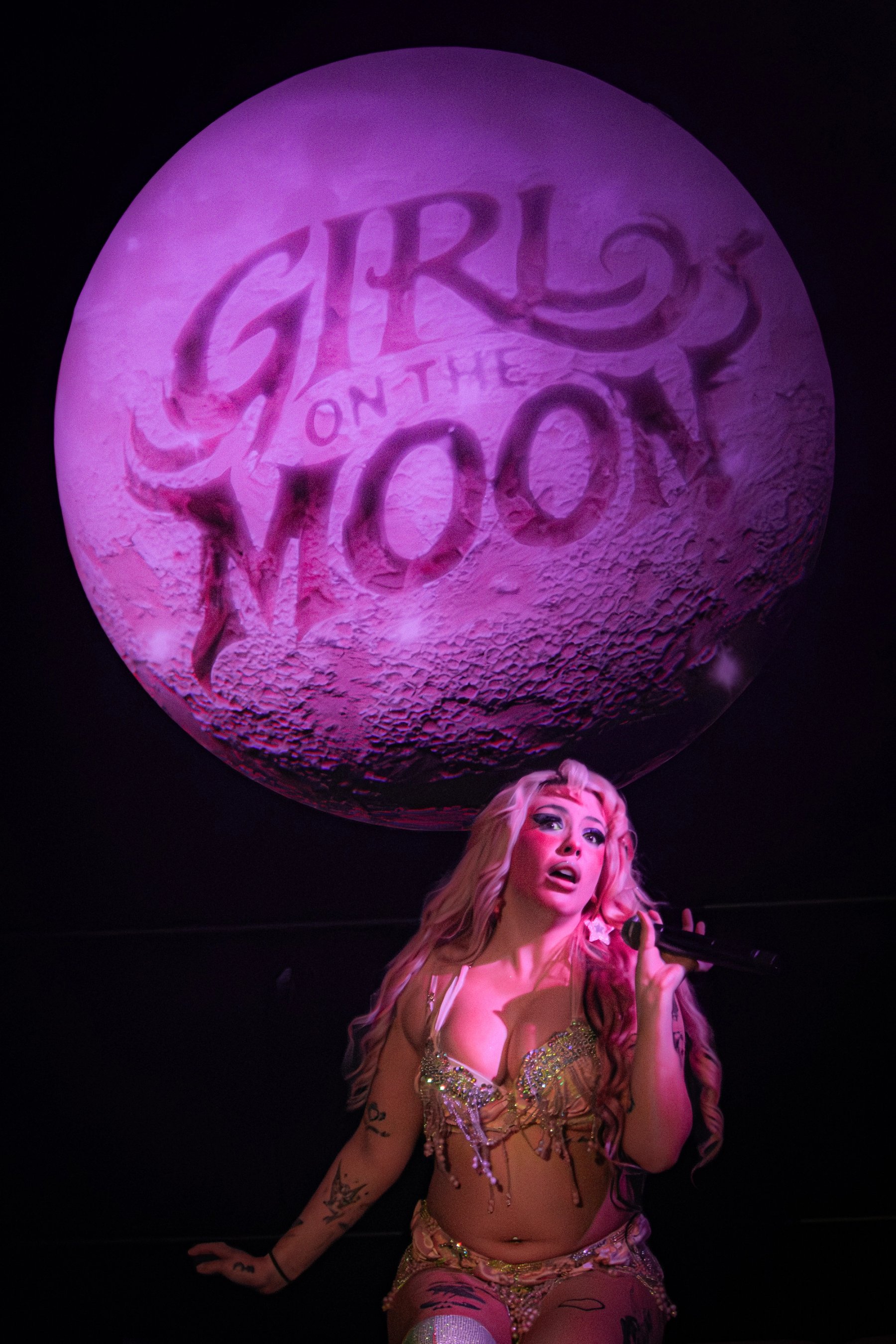 Chlapecka on stage beneath the giant Girl on the Moon backdrop at Modus Berlin
