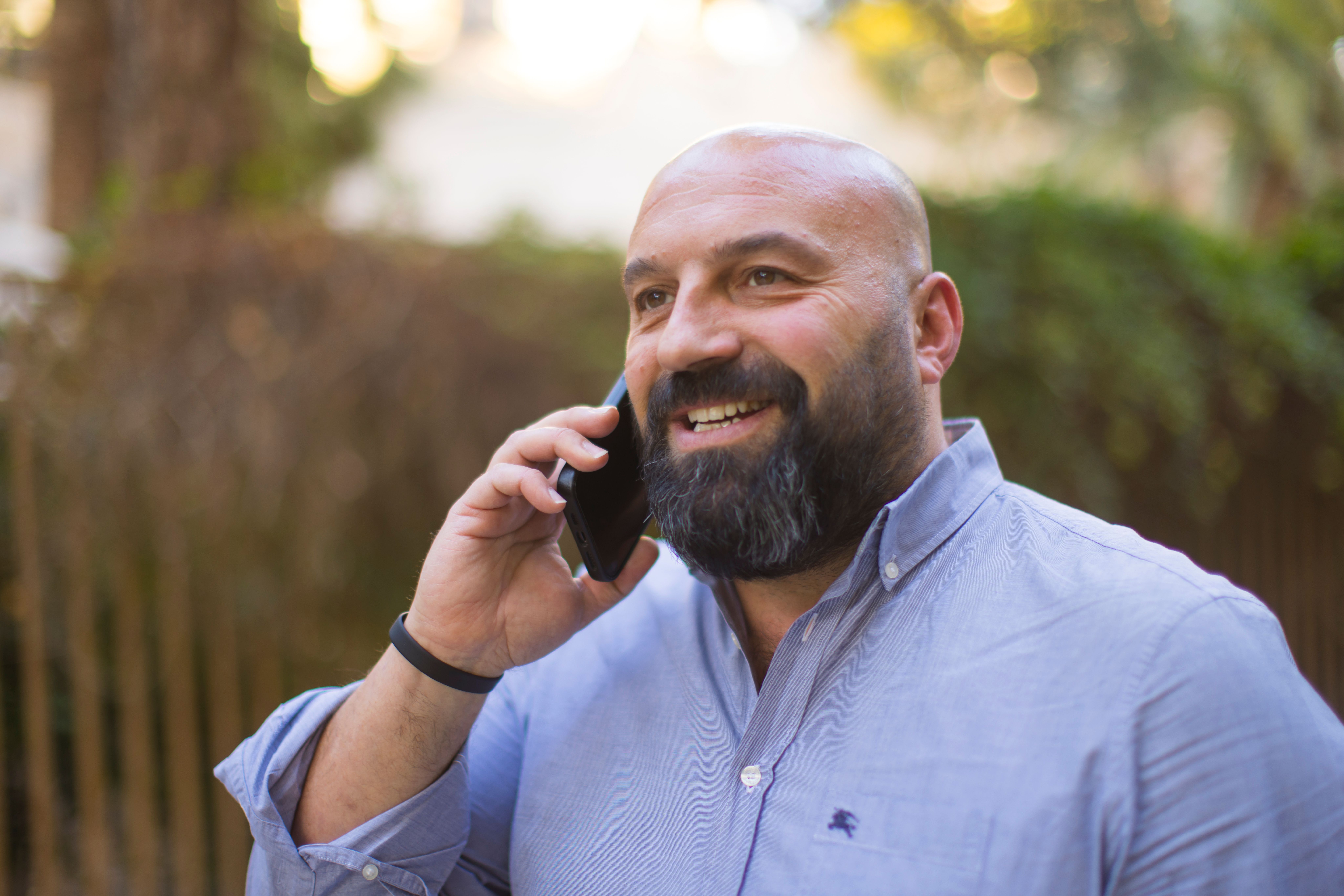 Nik Kyroudis on mobile phone. 