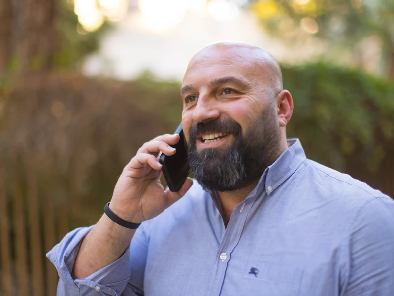 Nik Kyroudis on mobile phone.