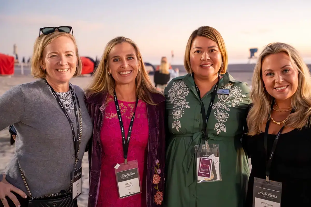 Four attendees posing for a photo together