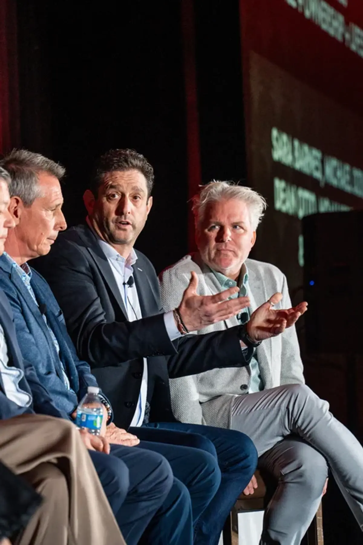 Panel of speakers presenting on stage