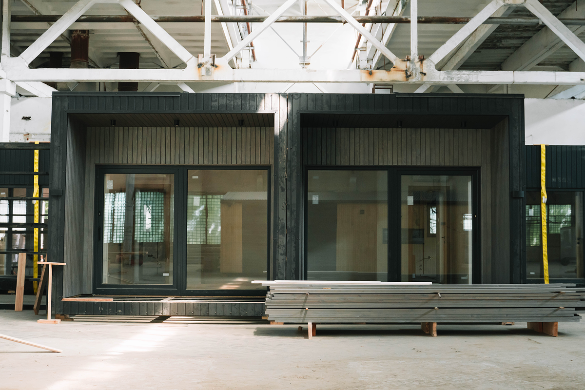 A new wooden modular prefabricated house inside in manufacturing facility.