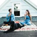 Emma, Jordan, and Levi the dog eating watermelon on a rooftop.