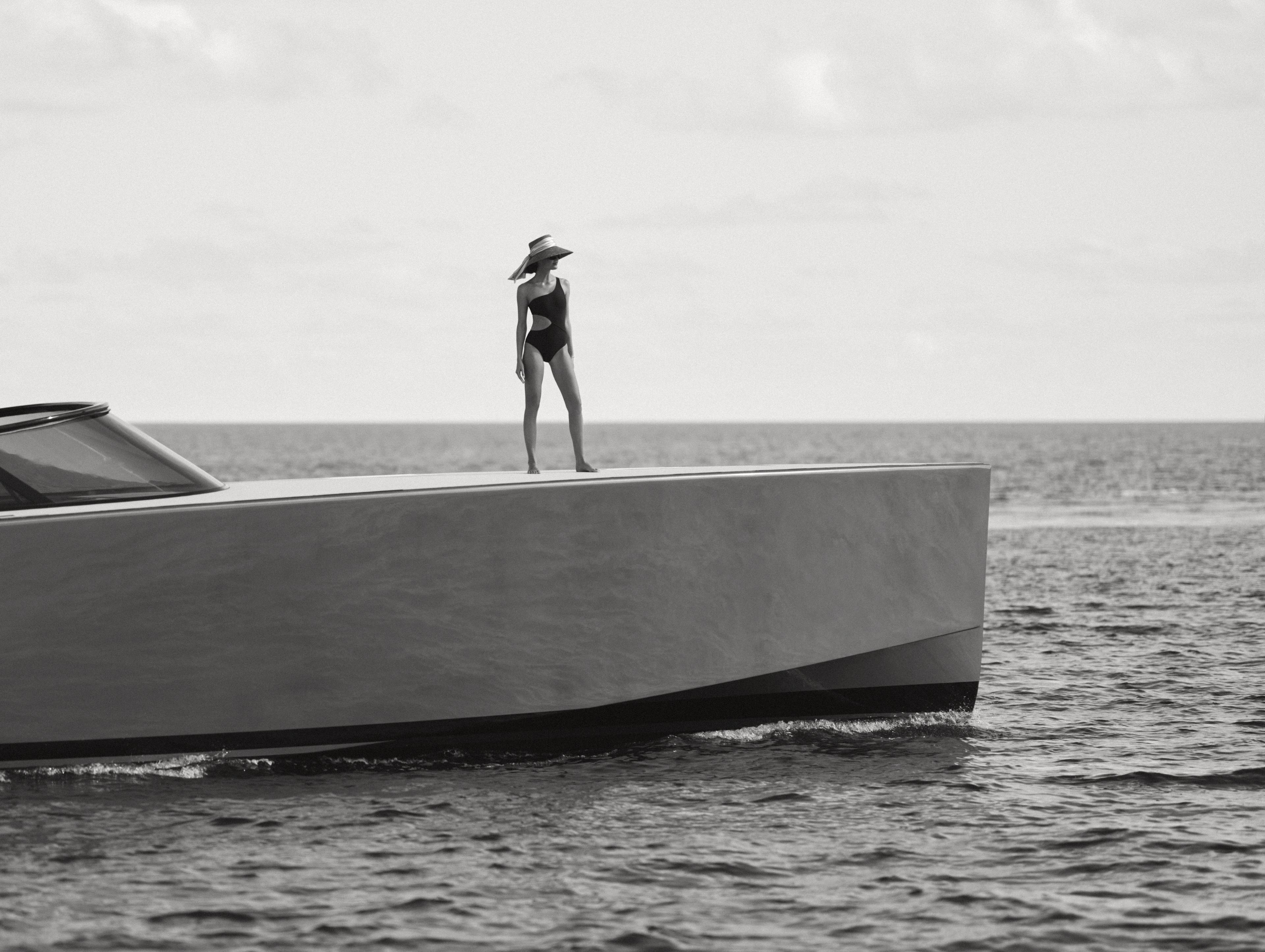 Woman standing on a boat at sea.