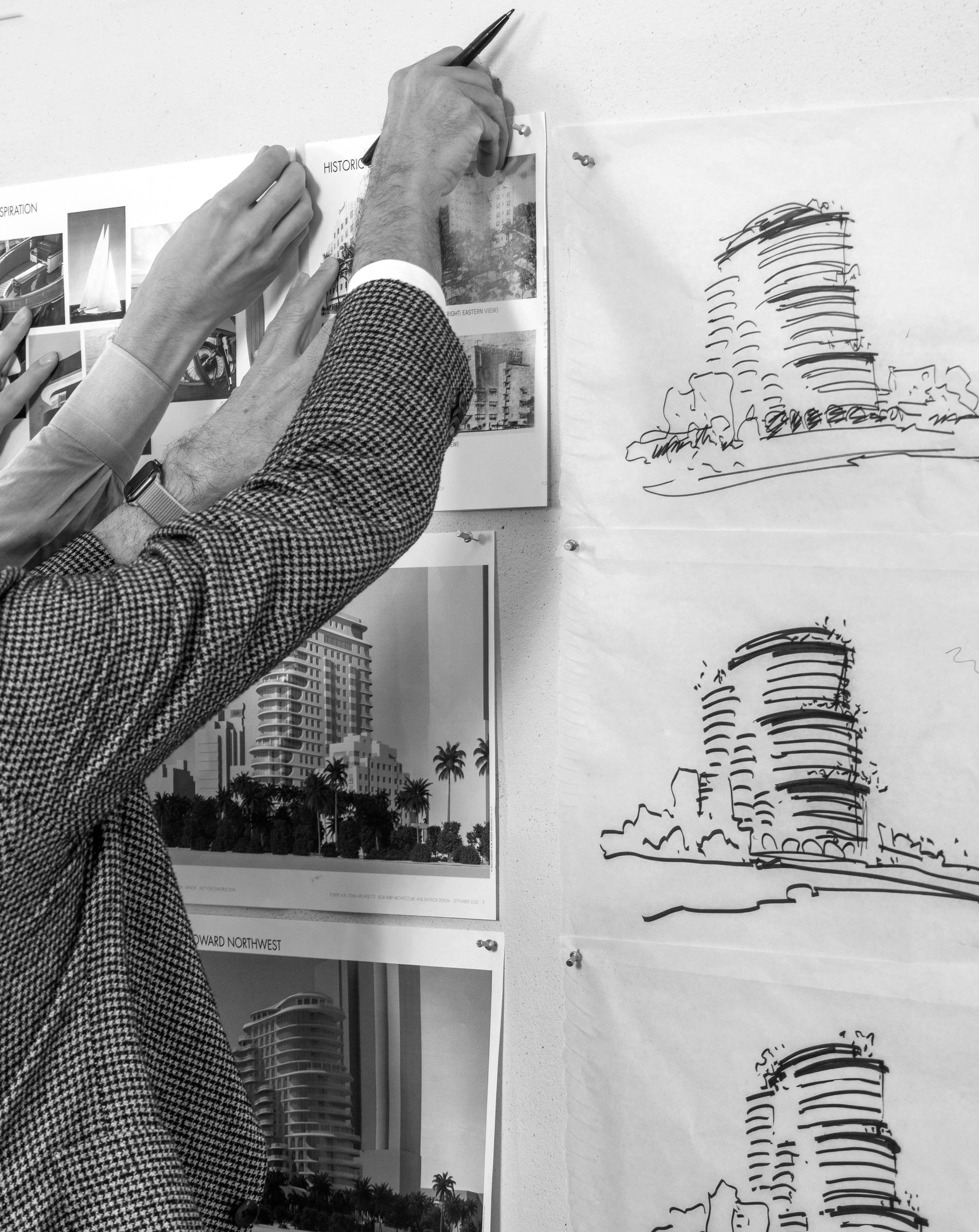 RAMSA architects working on drawings.