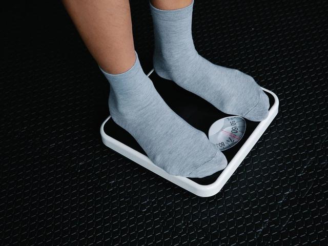 Person standing on a weight scale