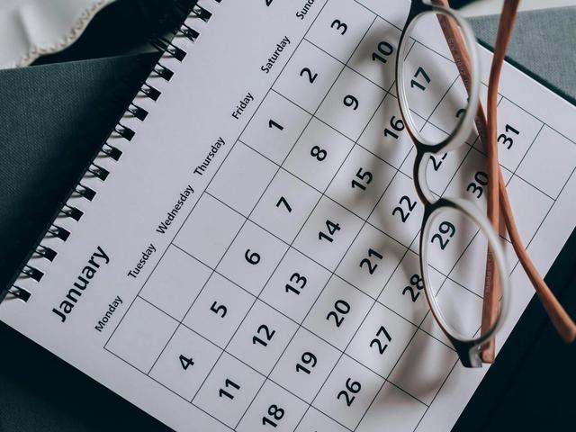 Brown framed glasses on a calendar