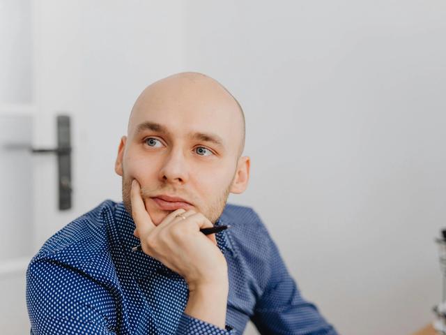 Man leaning on his hand thinking