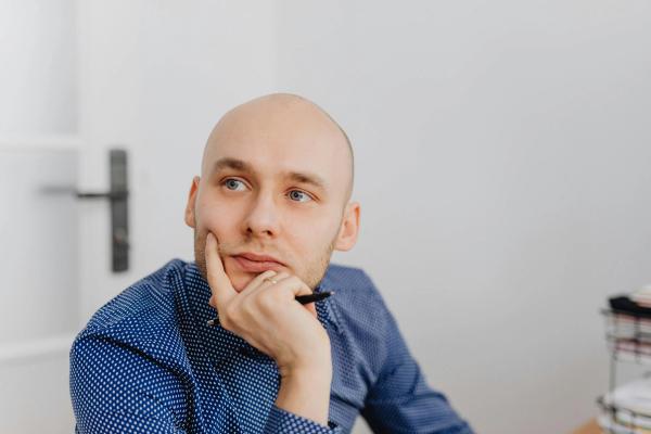 Man leaning on his hand thinking