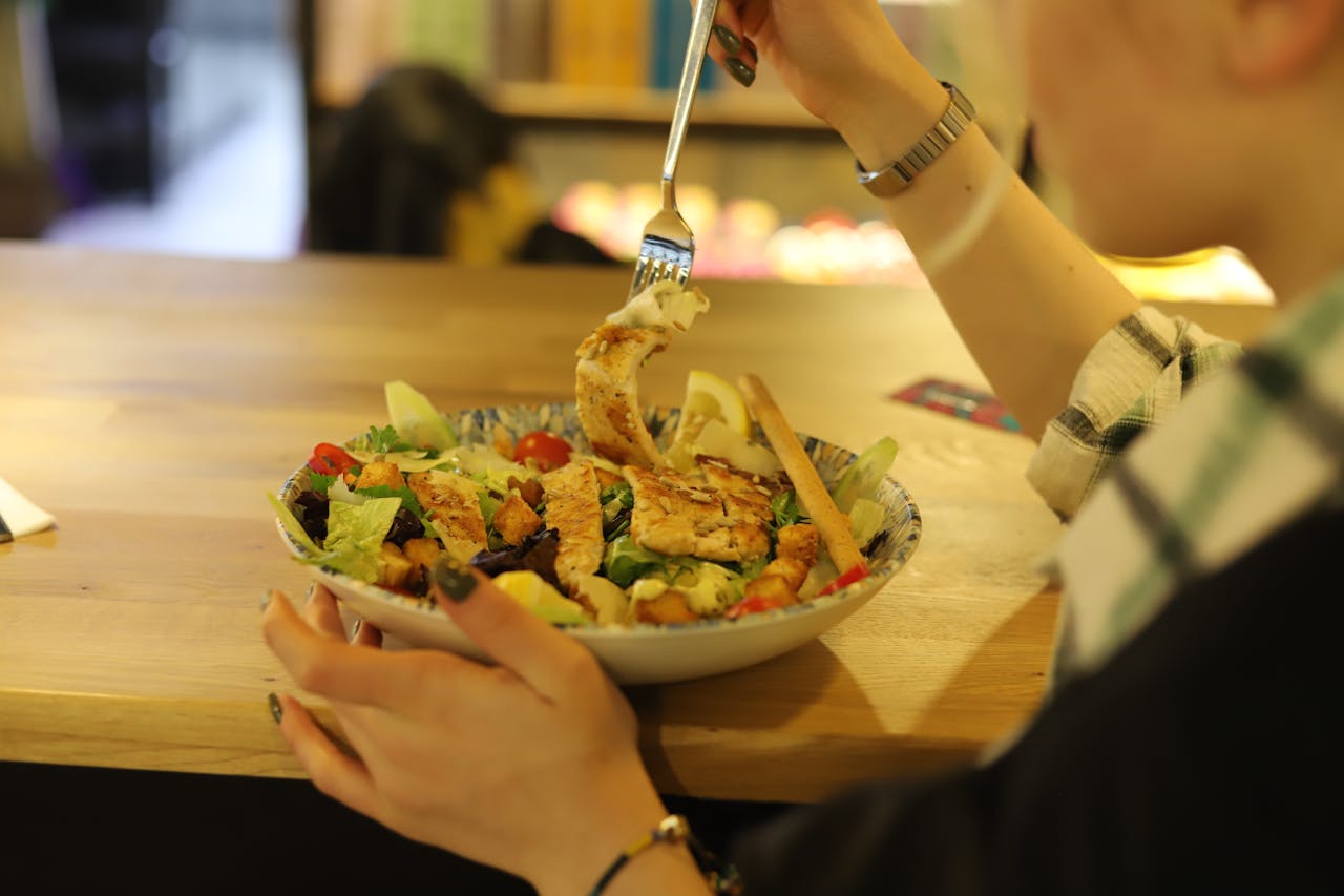 A person eating a salad