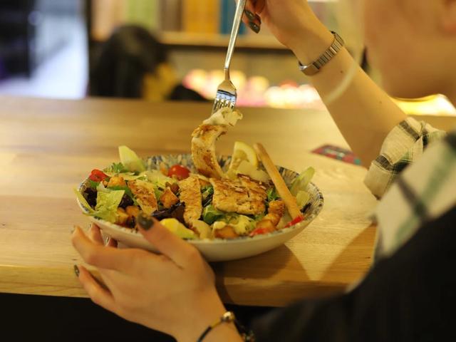 A person eating a salad