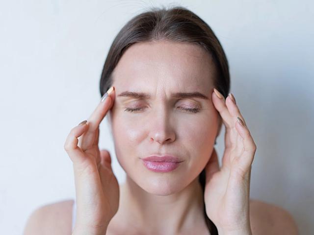 Woman experiencing a headache
