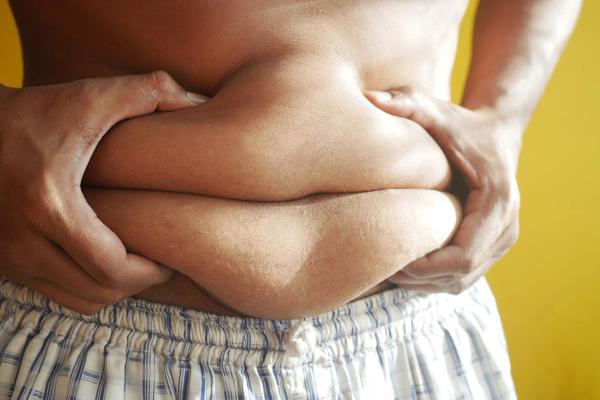 Person holding onto belly fat