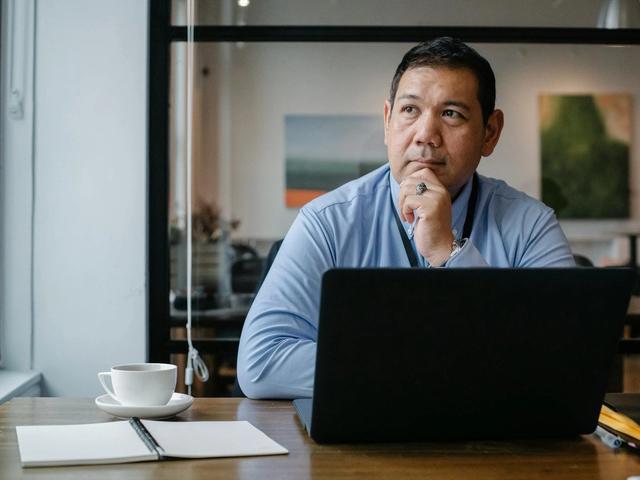 Man thinking at a computer
