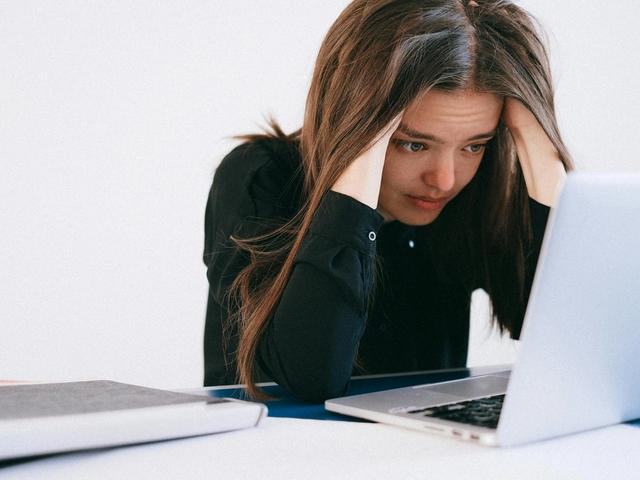 Stressed woman looking at a laptop