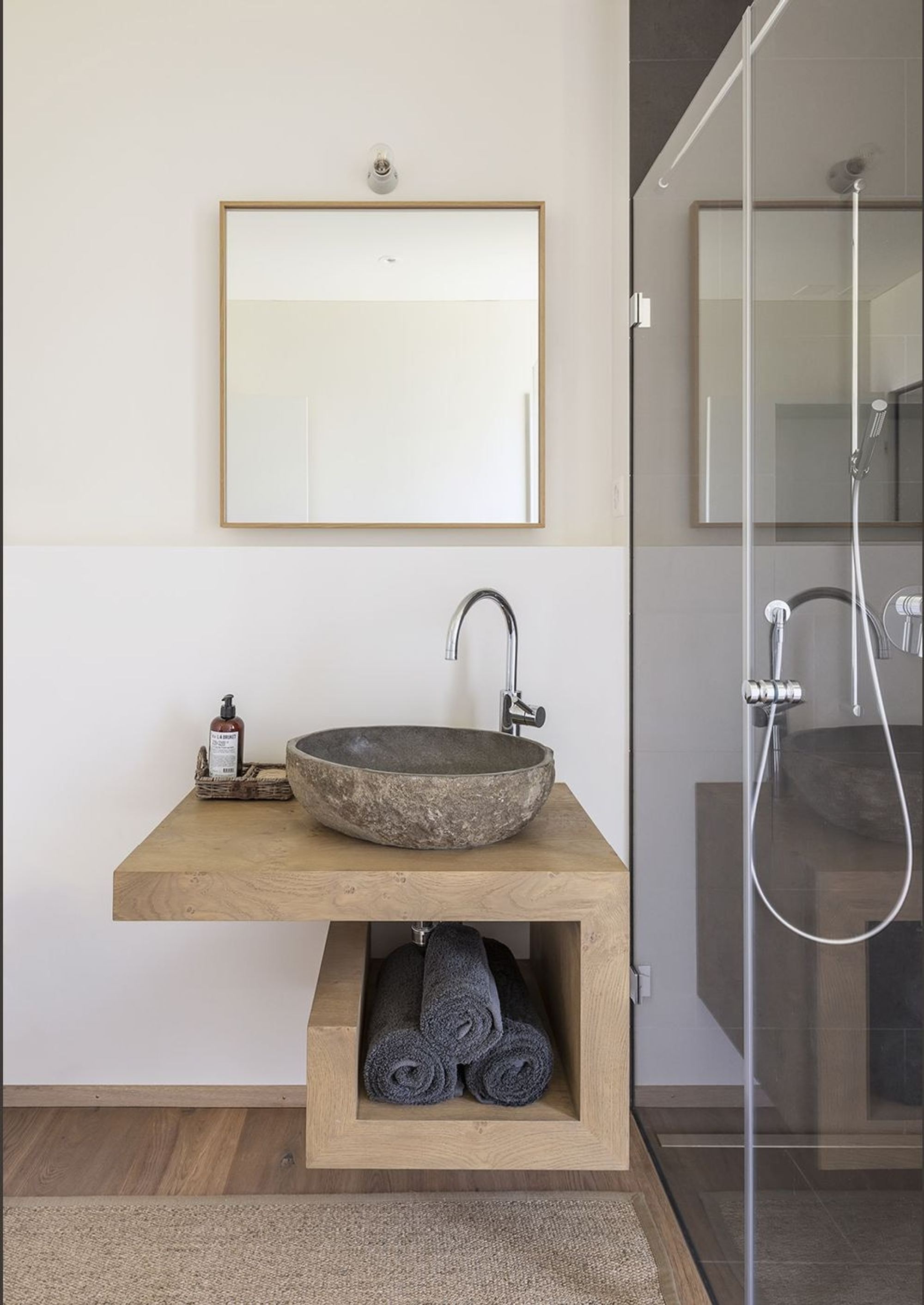 Timber vanity with stone basin next to the shower – Single-family house in Grüningen