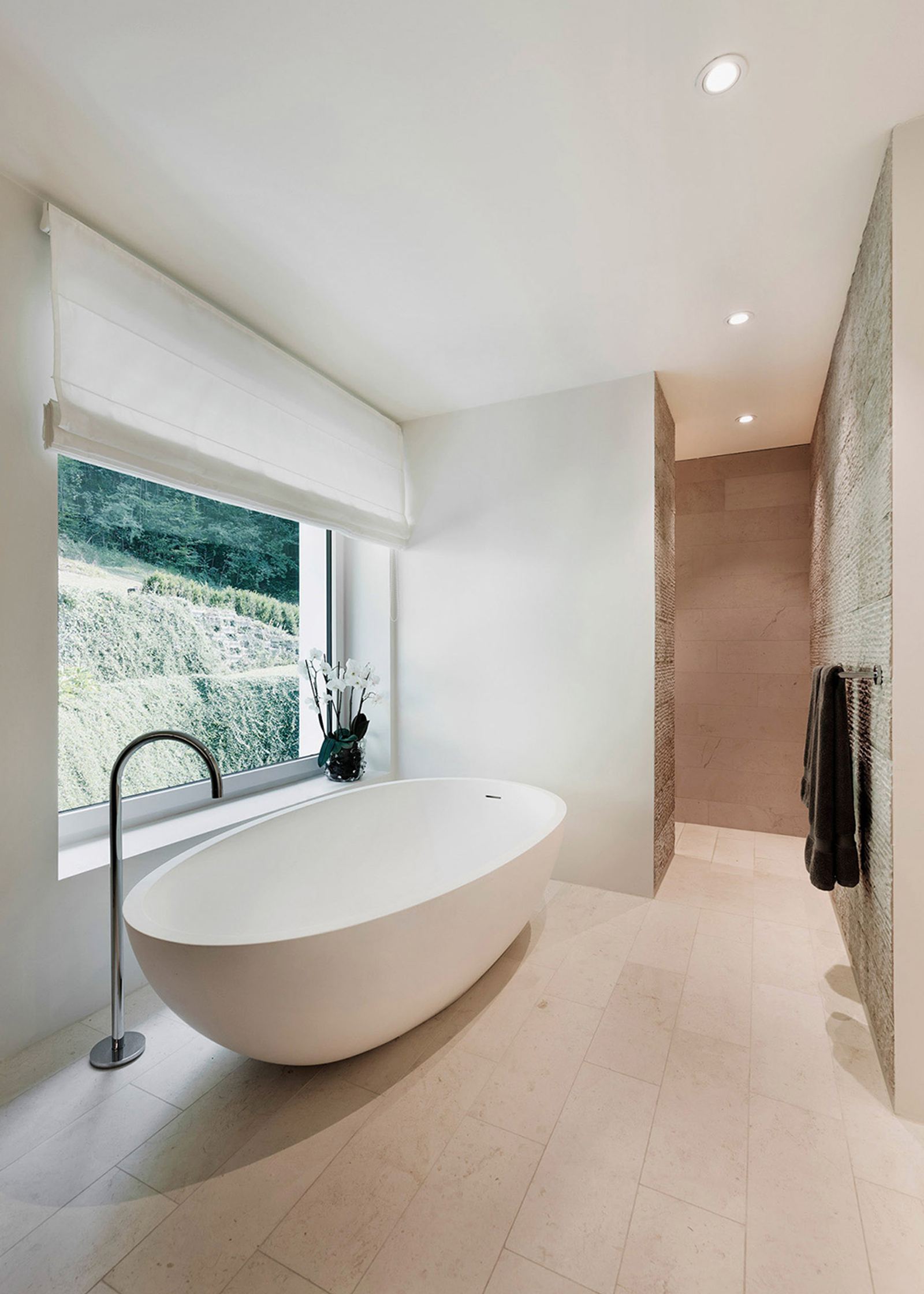 Freestanding bathtub by the window