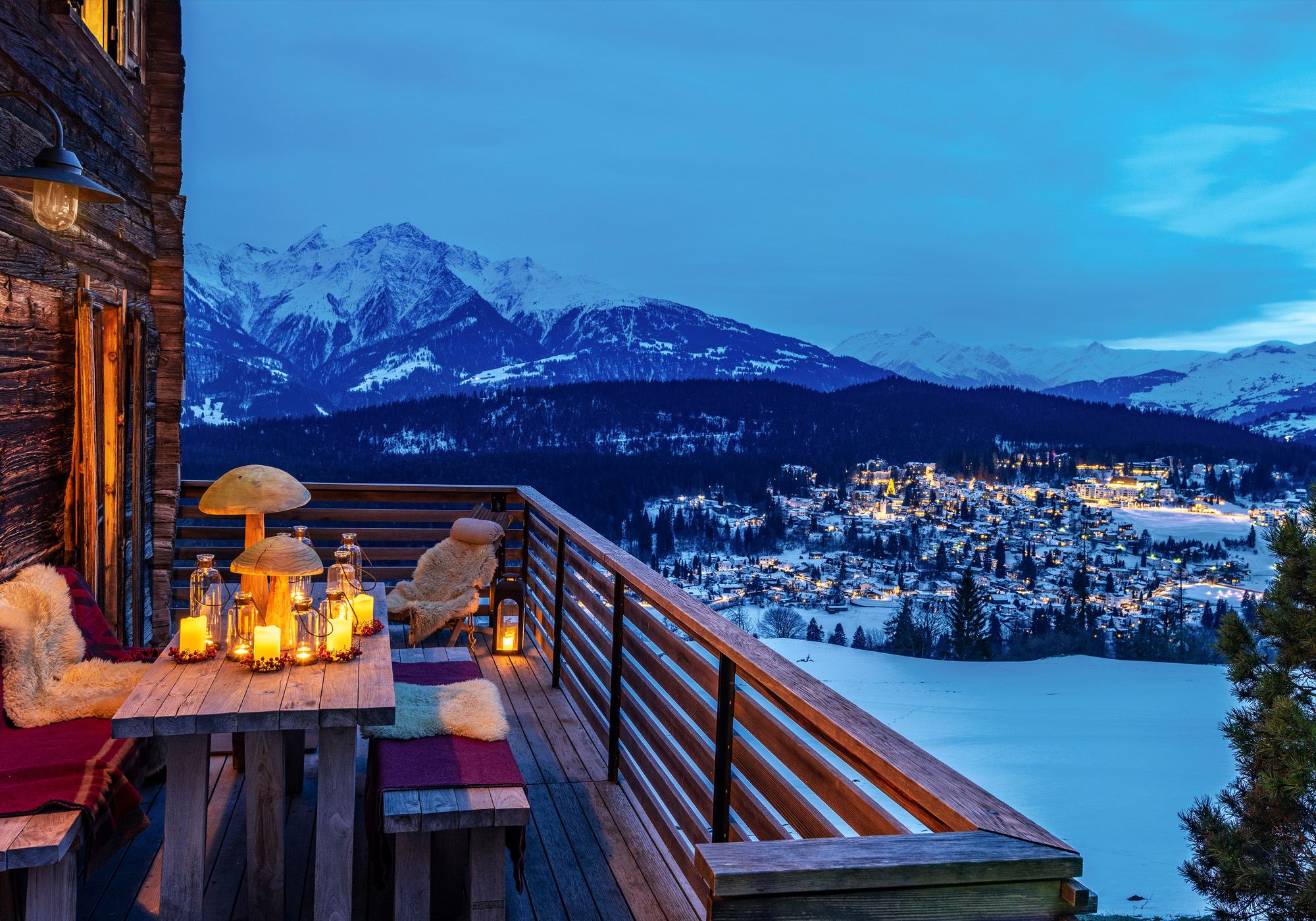 Balcony with lanterns overlooking a snowy mountain village – Historic conversion in Fidaz