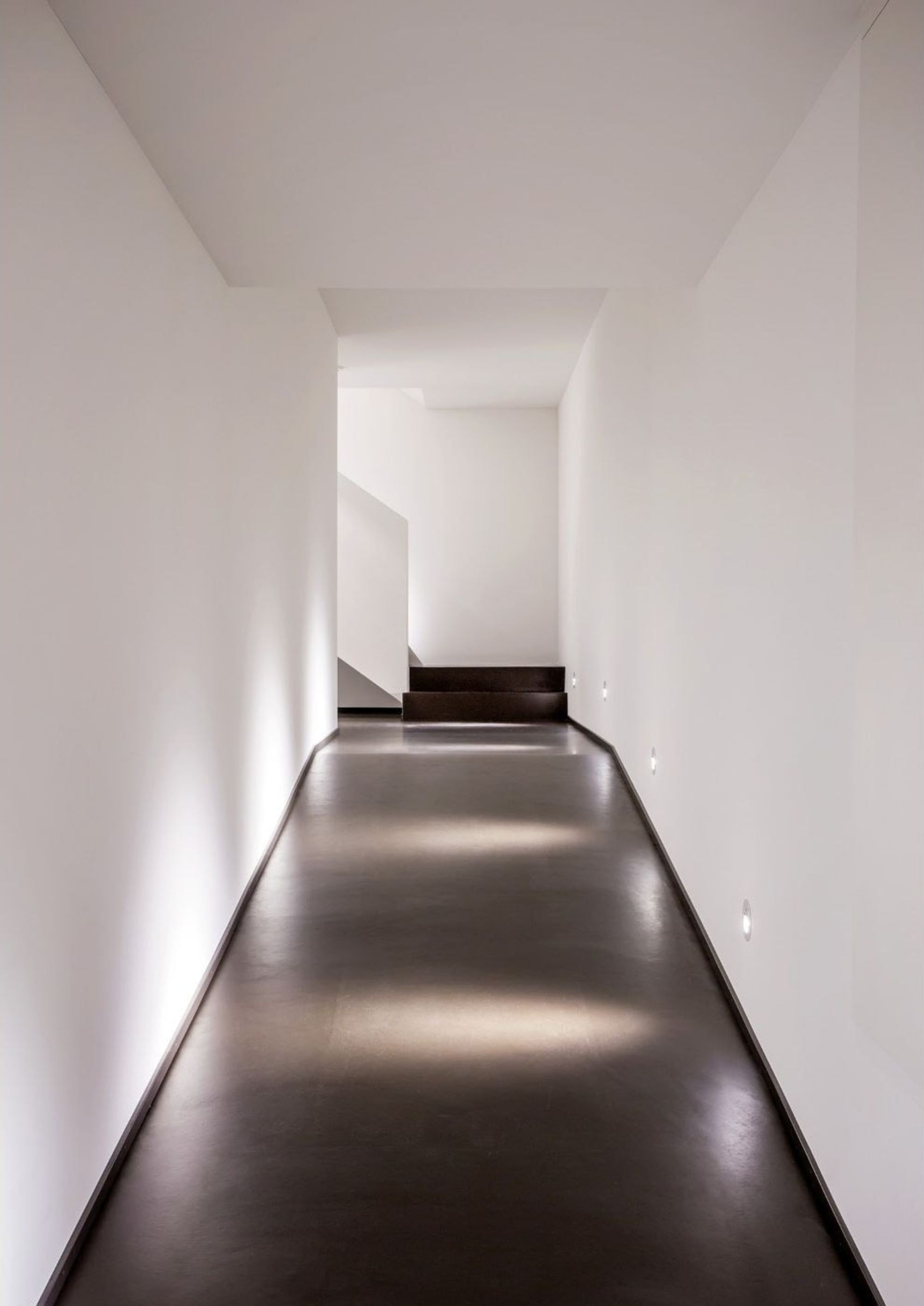 Long corridor with floor lights – Apartment building in Uitikon