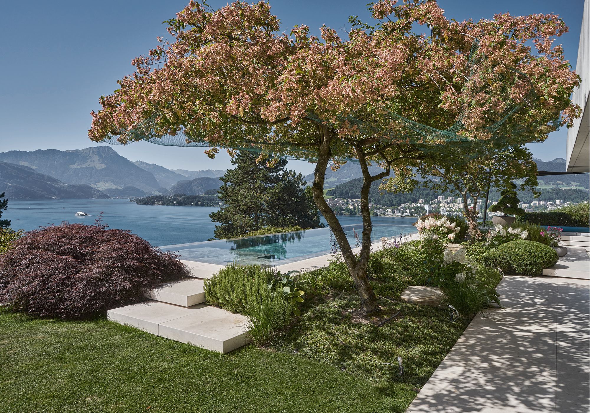 Garden with maple, stepping stones and lake view – Interiors and landscape, Luzern
