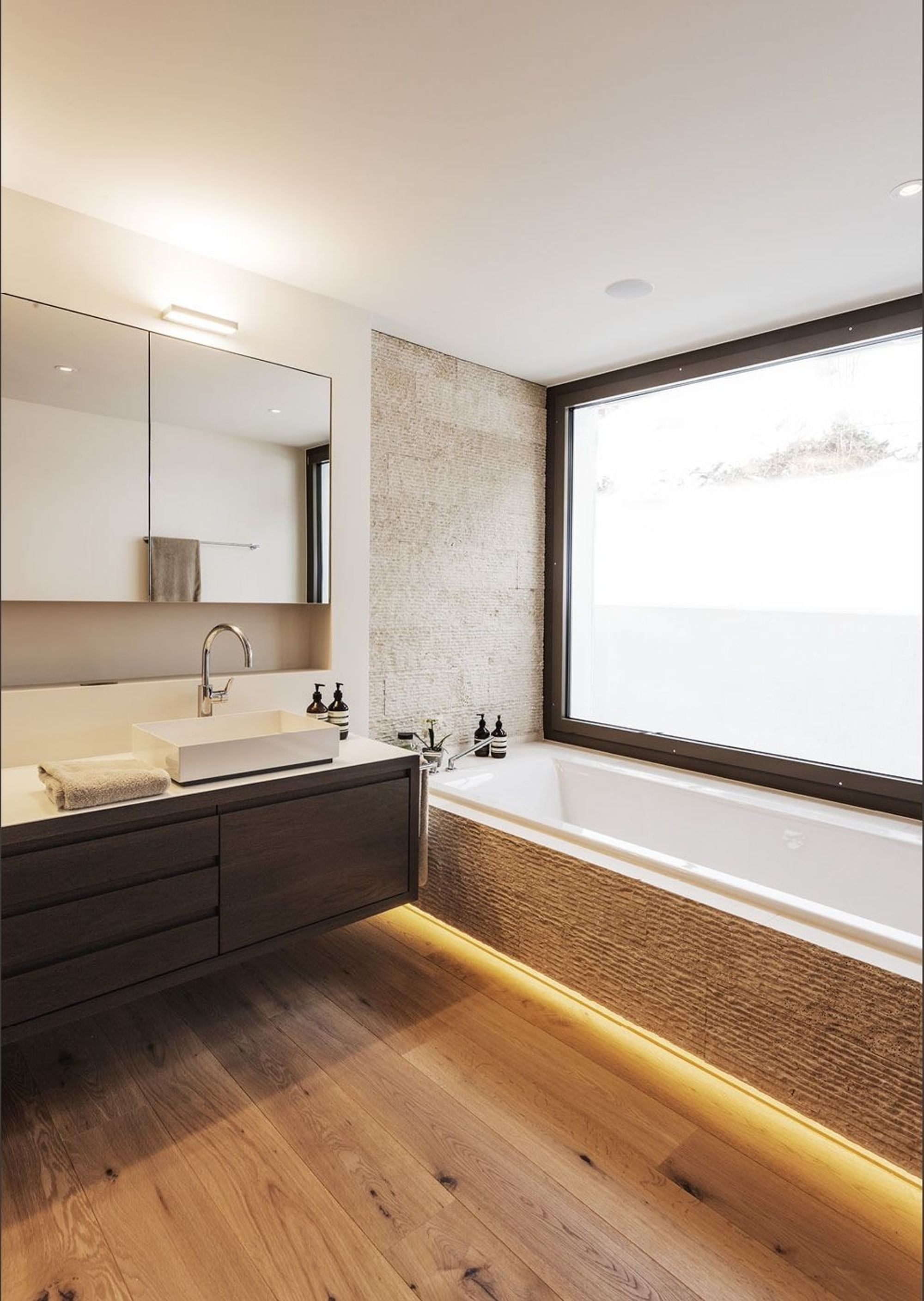 Bathroom with bathtub, timber floor and large window – Interiors and landscape, Herrliberg