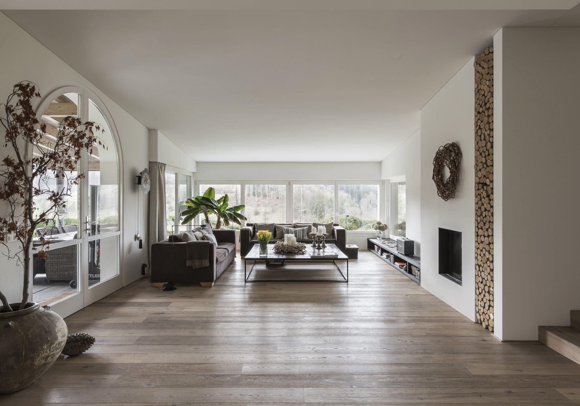 Large living room with oak floor and fireplace – Interiors and landscape, Stallikon