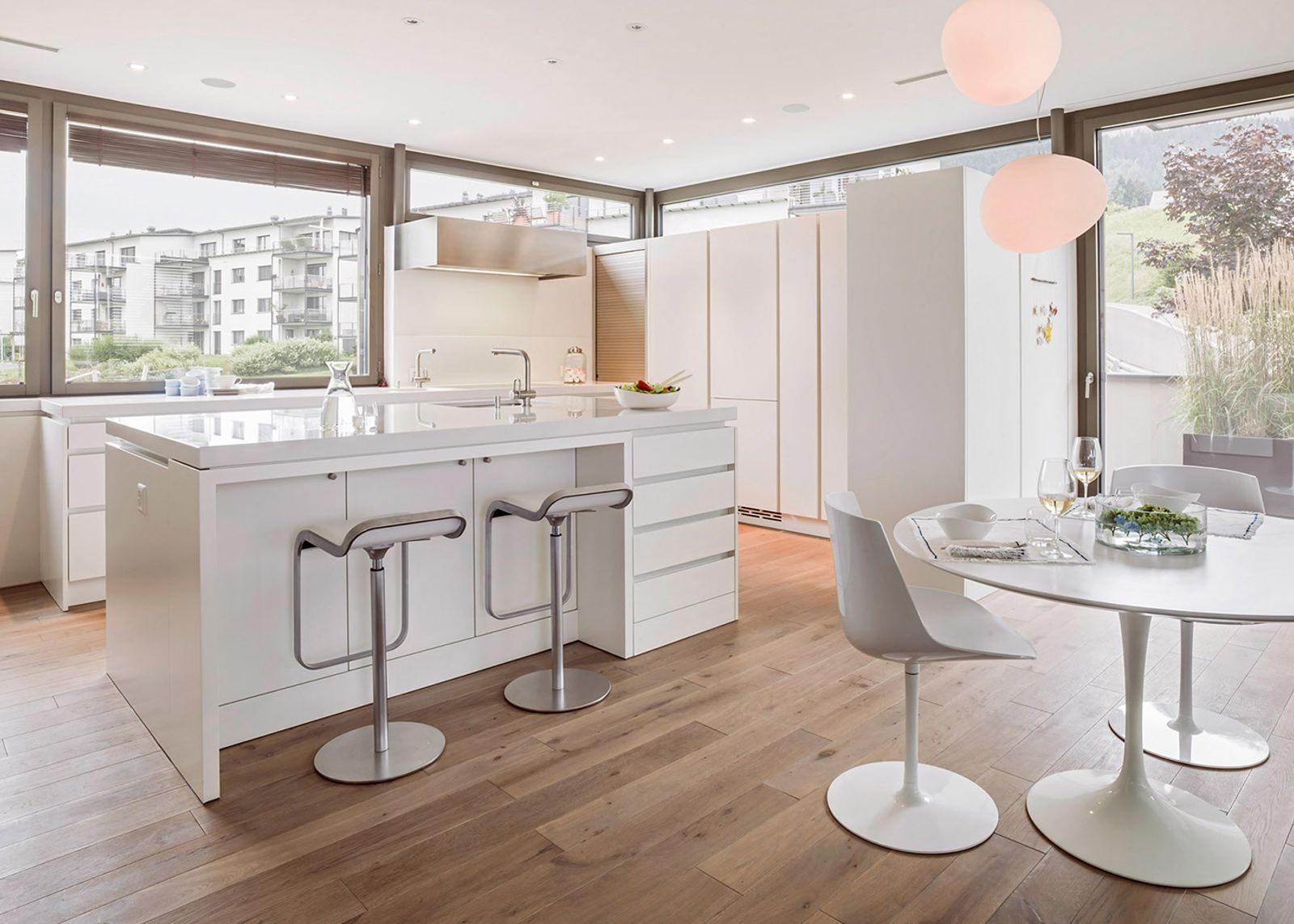 White kitchen with bar stools and round table