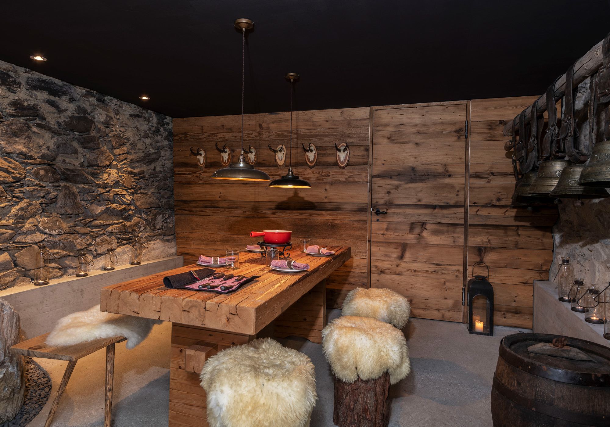 Cellar room with natural stone wall and timber table – Historic conversion in Fidaz