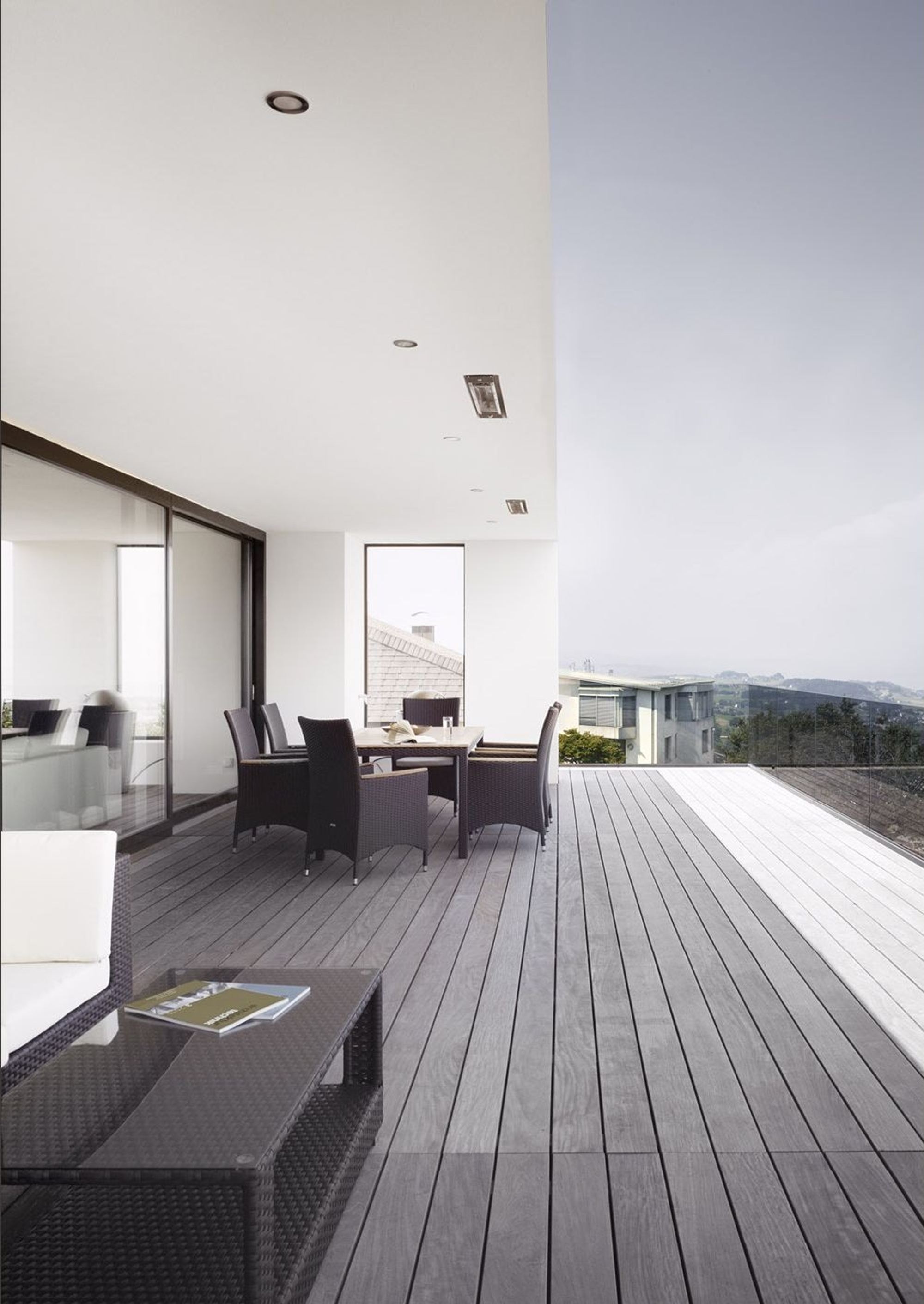 Covered terrace with timber floor and seating – Single-family house in Schindellegi