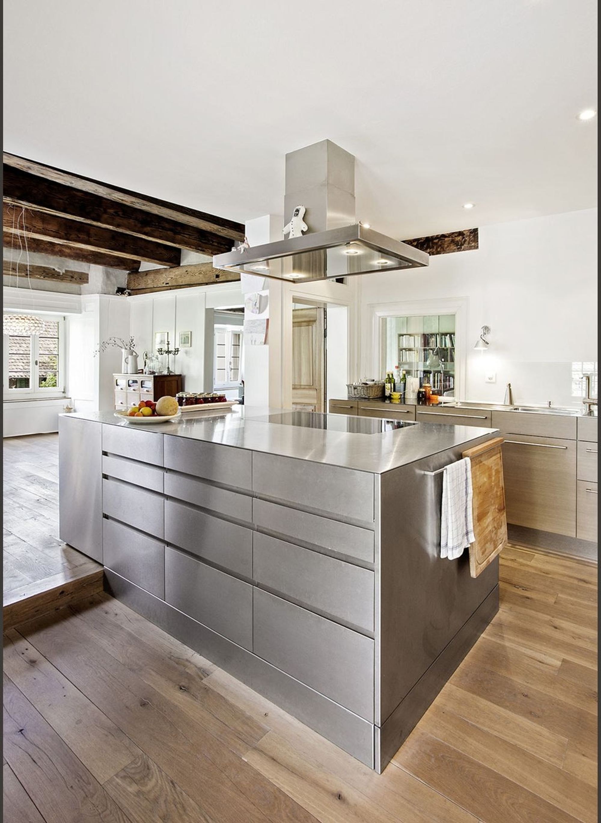 Stainless steel island with timber floor – Historic conversion in Uerikon