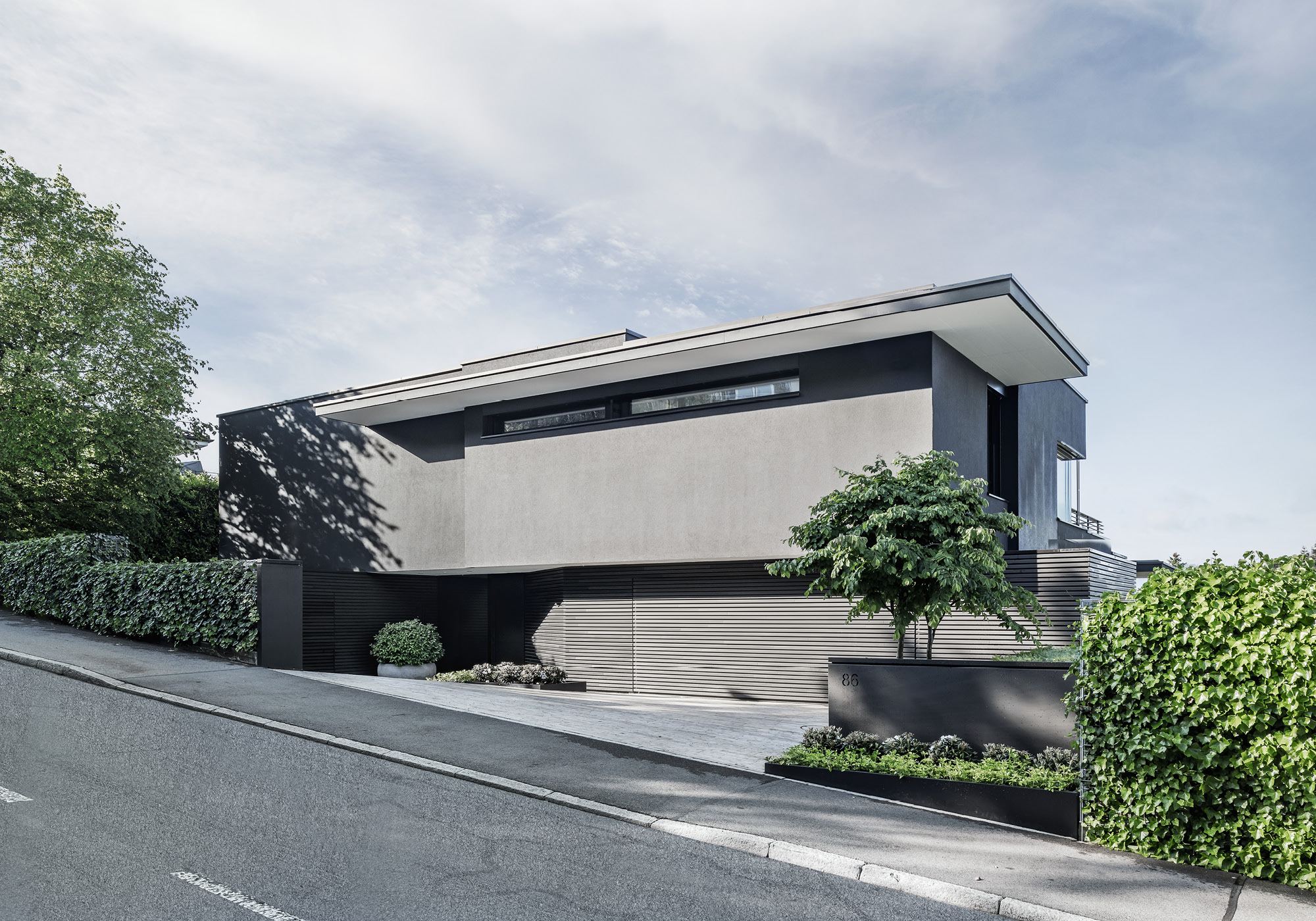Hillside house by the road with garage and front garden – Single-family house in Meilen