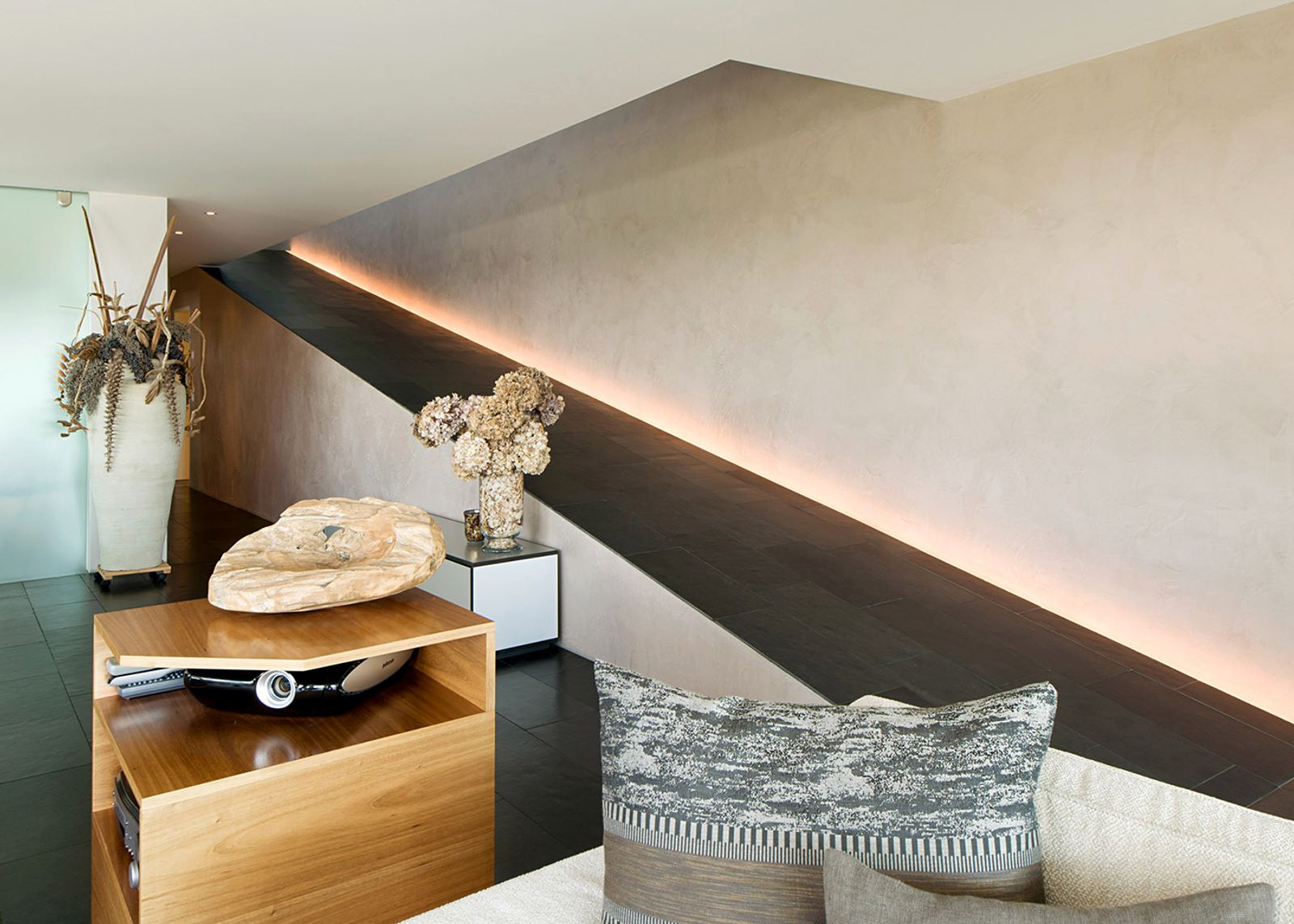 Stair stringer with light strip above the sofa