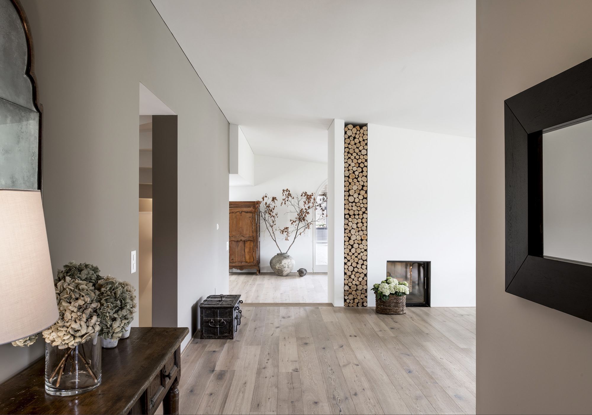 Entrance area with console table and view into the living room – Interiors and landscape, Stallikon