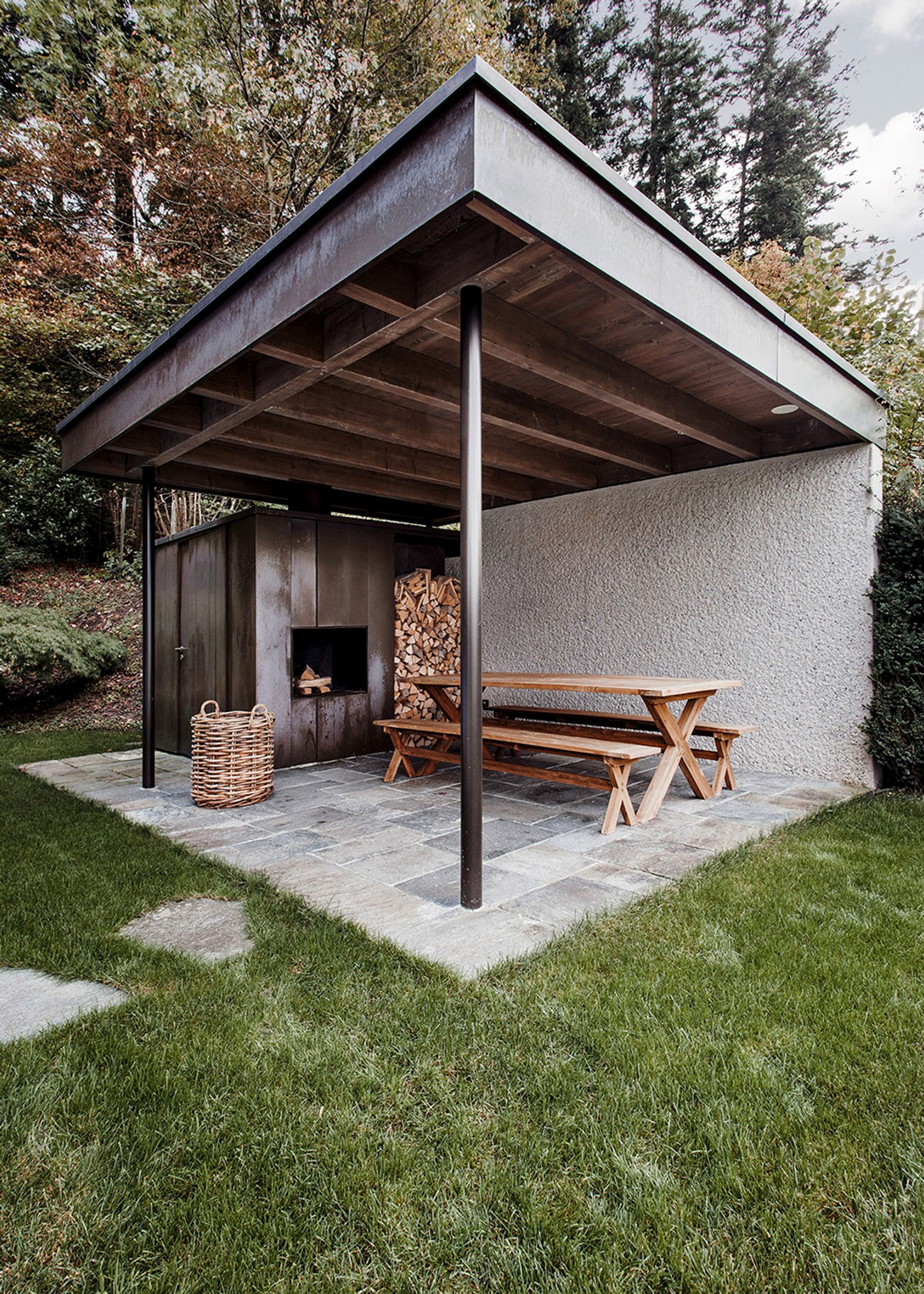 Covered seating area with fireplace and timber table